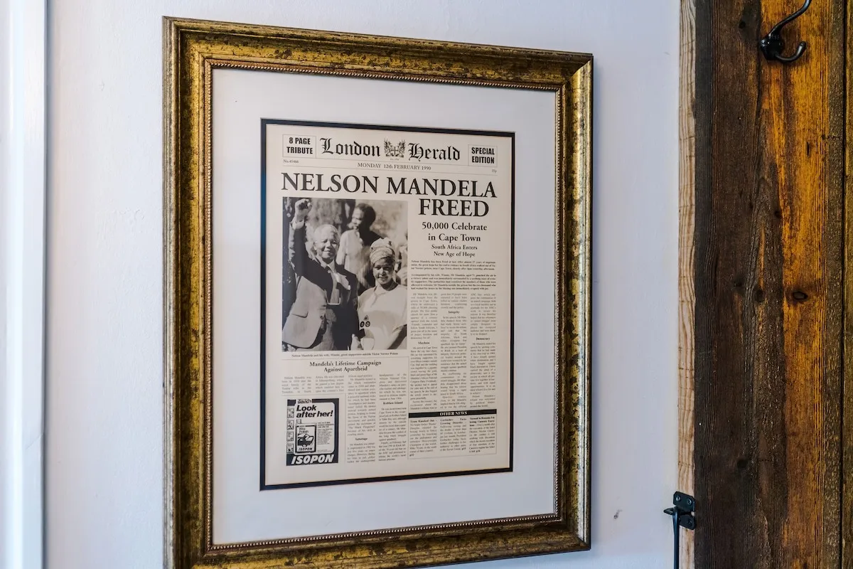 Framed newspaper front page by the stairs