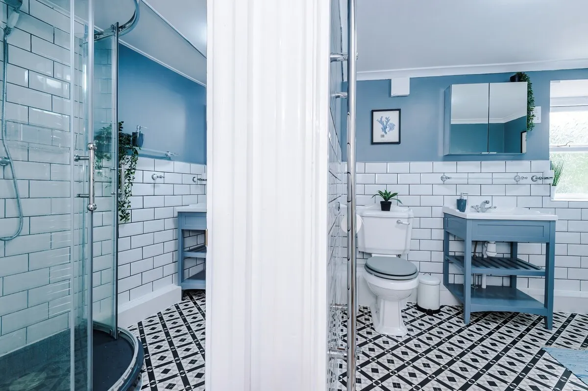 Shower and vanity through the bathroom door