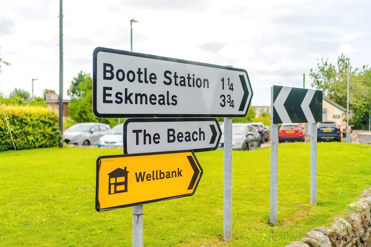 Road signs to Bootle station, Eskmeals and the beach