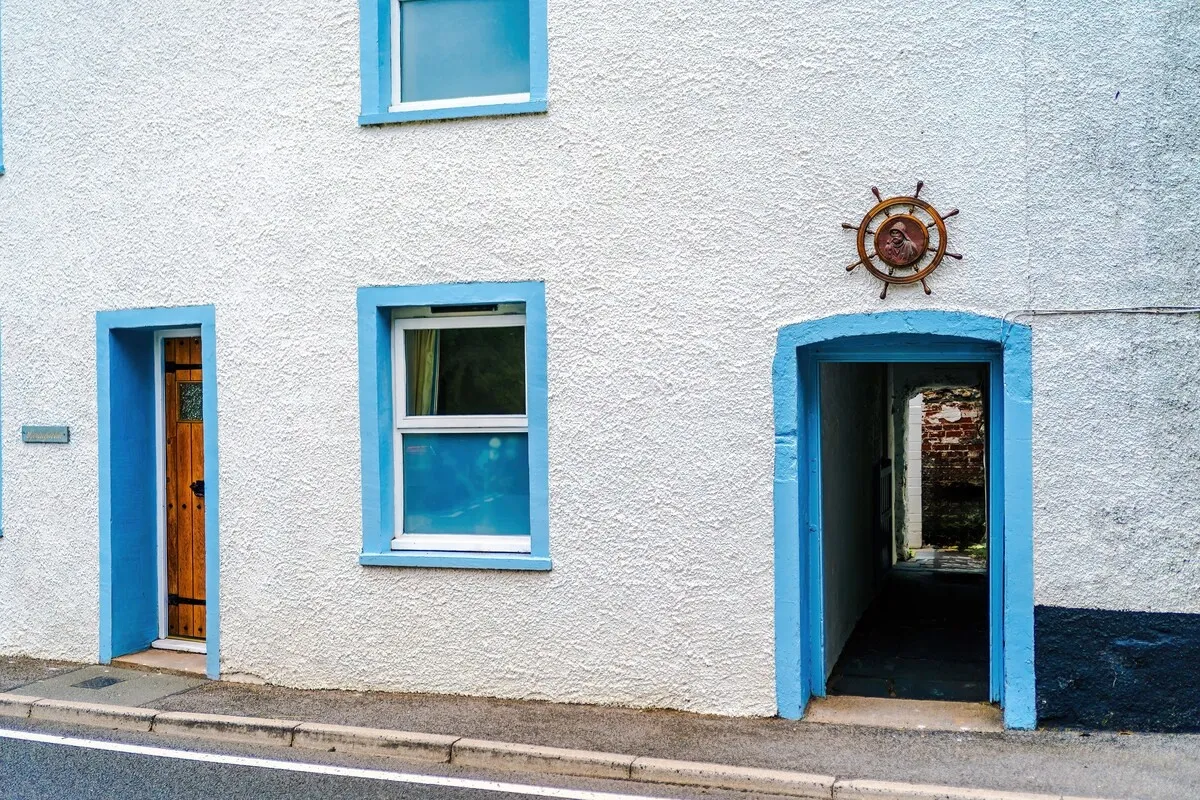 Front of the house with a ship’s wheel above the door