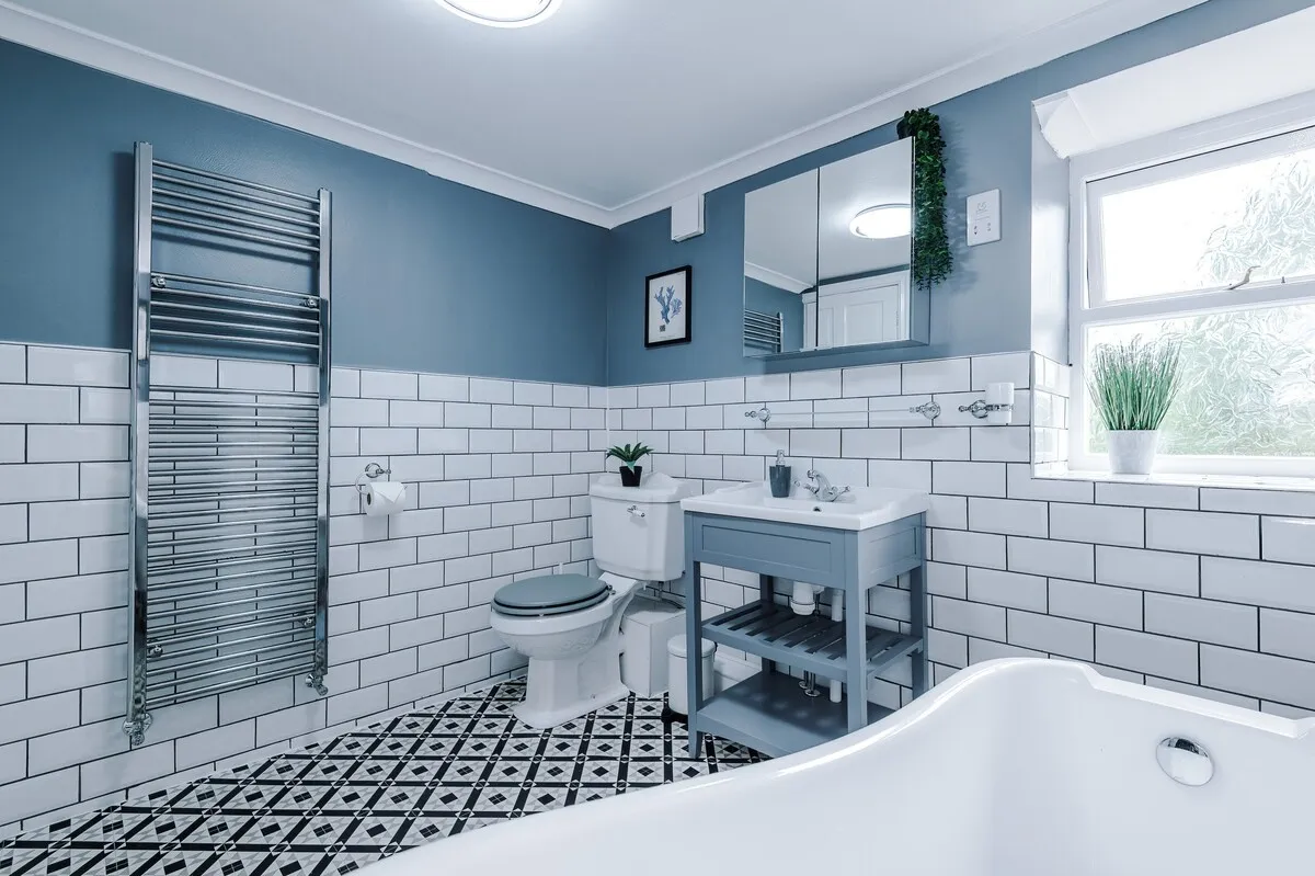 Bathroom with the bath, heated towel rail and vanity