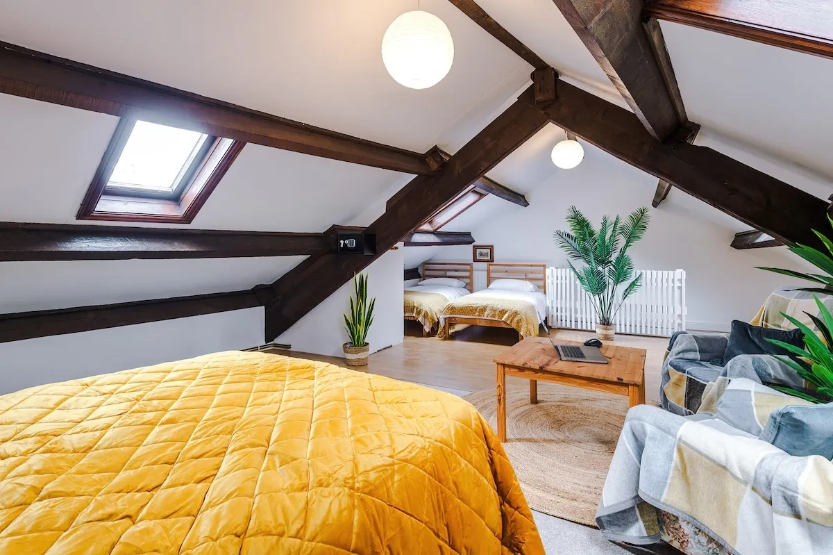 Attic bedroom with skylights and a second bed at the far end
