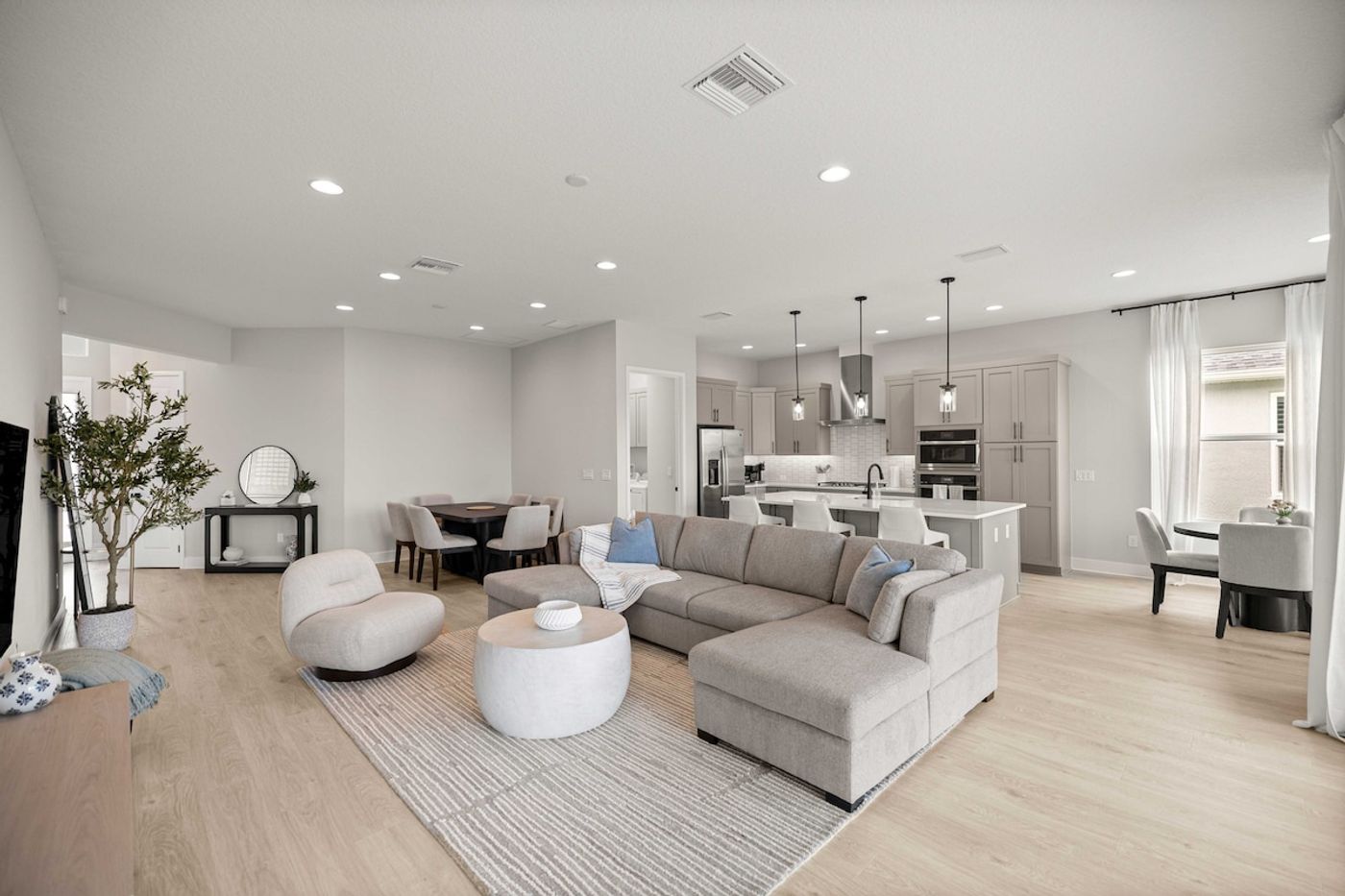 A bright open-plan living and kitchen area in a managed Villages rental home