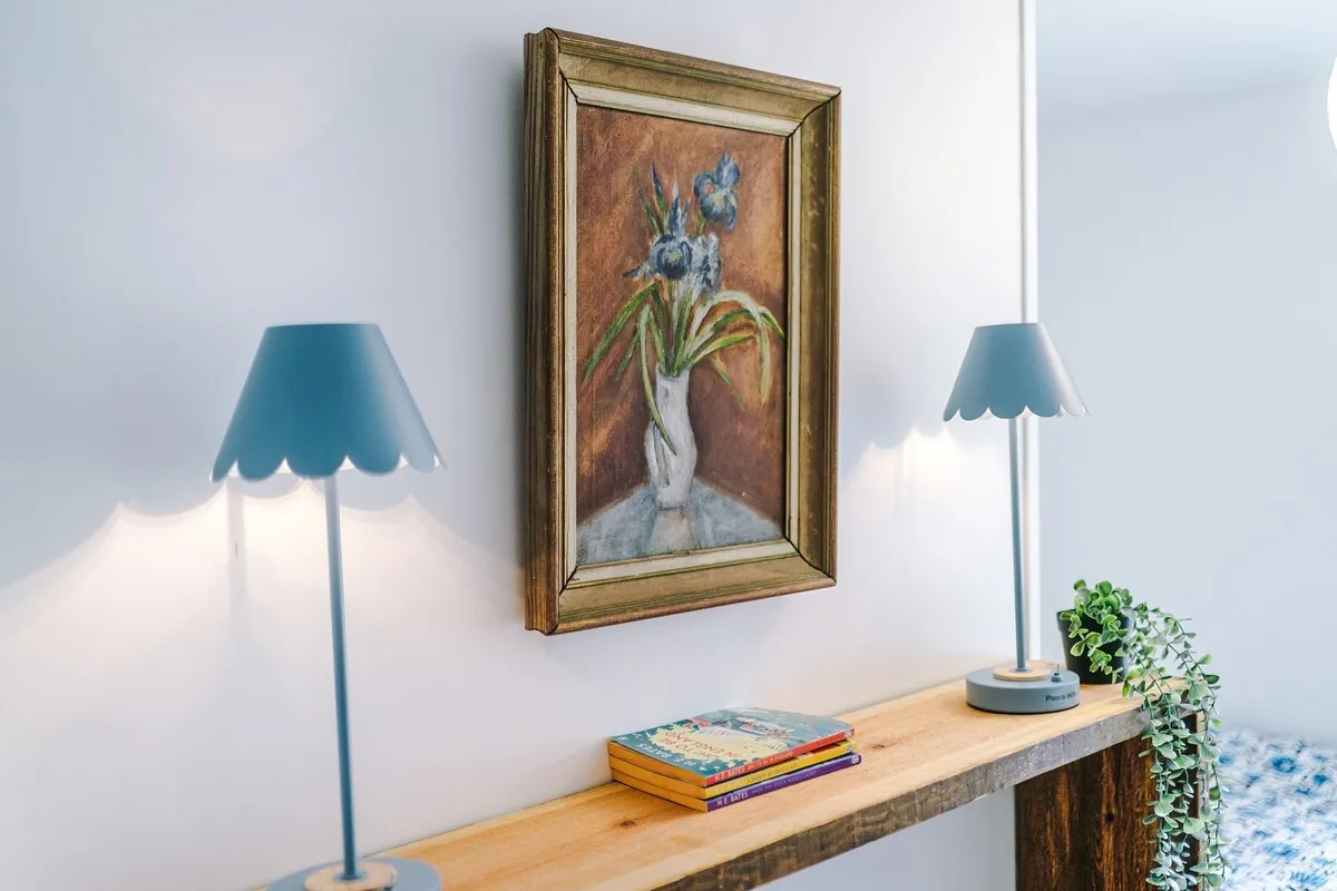 Console table with lamps and a painting
