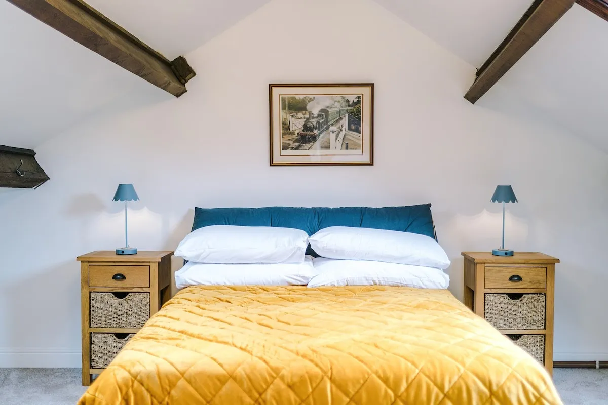 Attic double bed with bedside tables under the beams