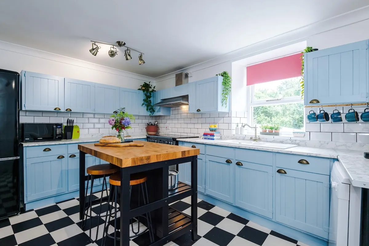 Kitchen with the range cooker, island and window over the sink
