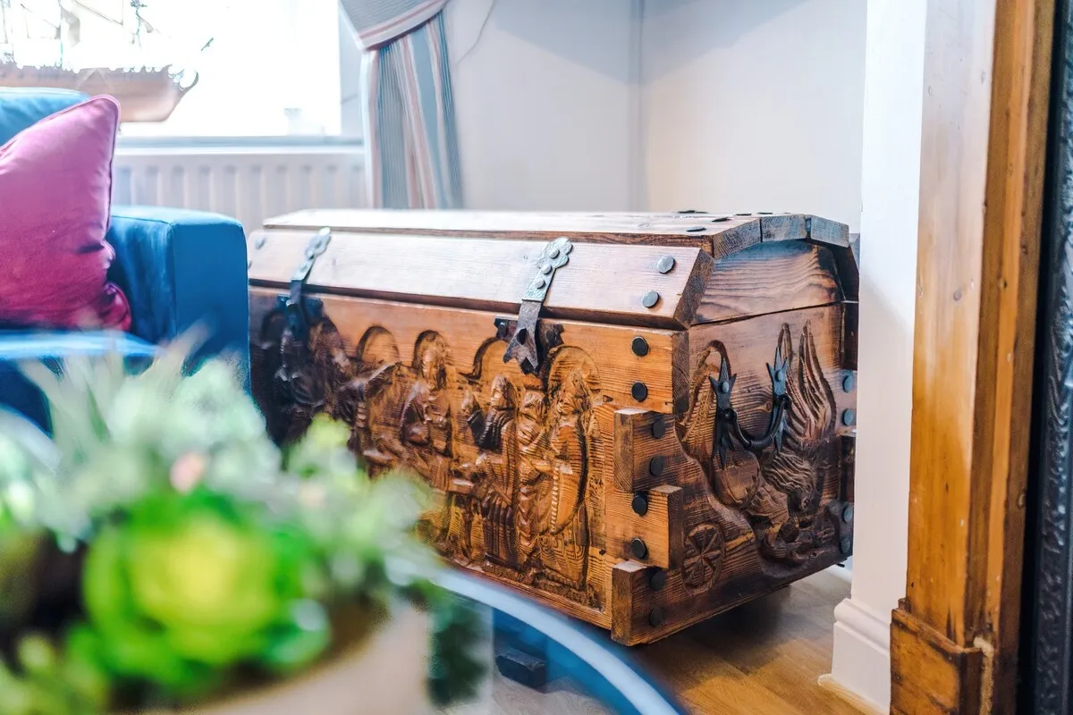 Carved wooden chest beside the sofa