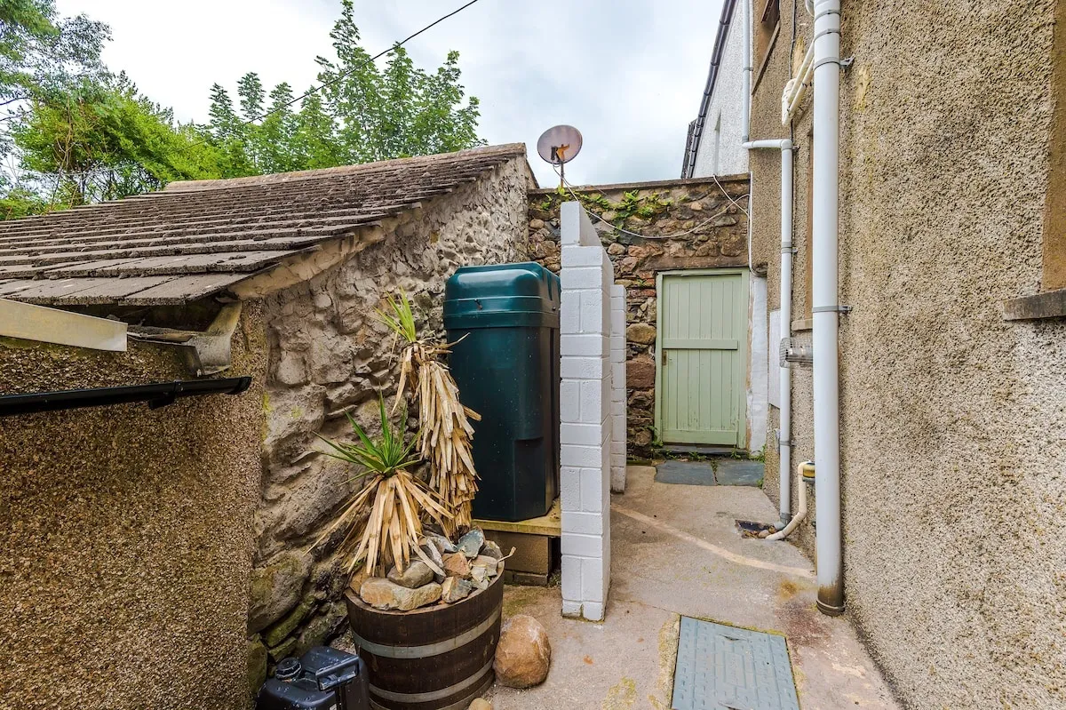 Back yard with a gate and water butt