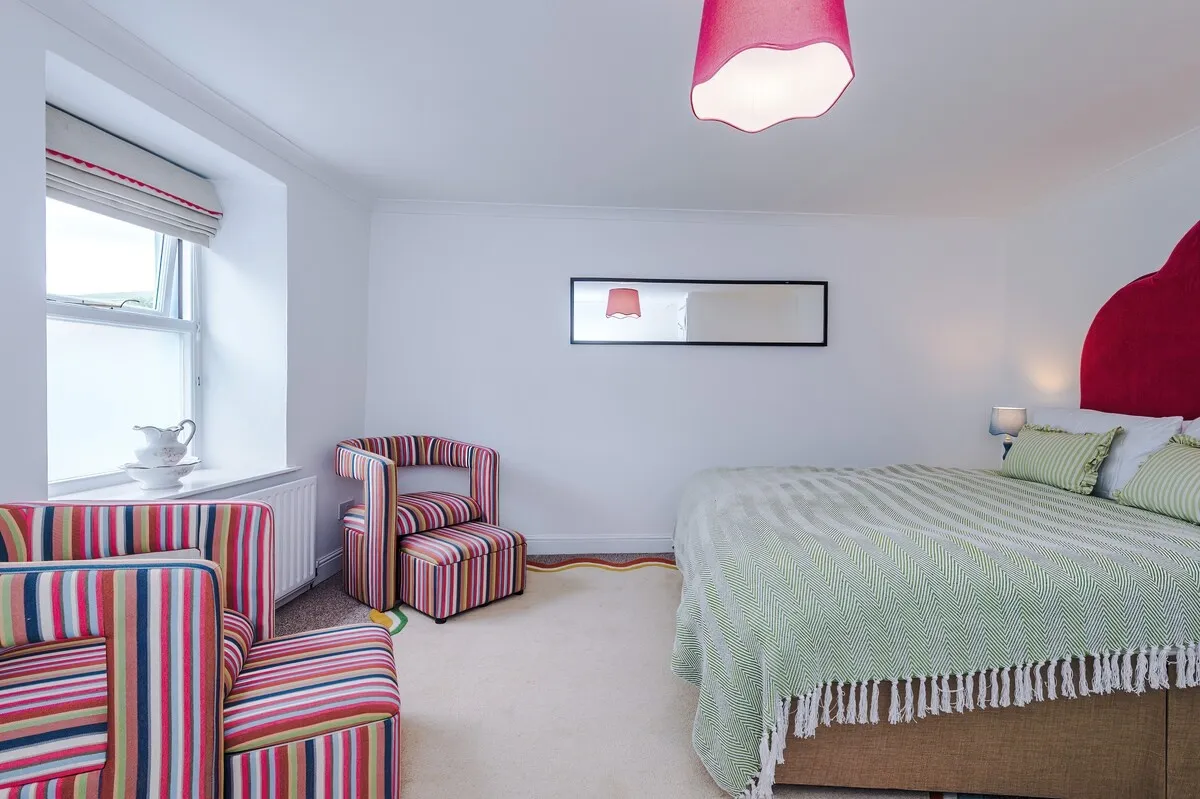 Striped armchairs by the bedroom window